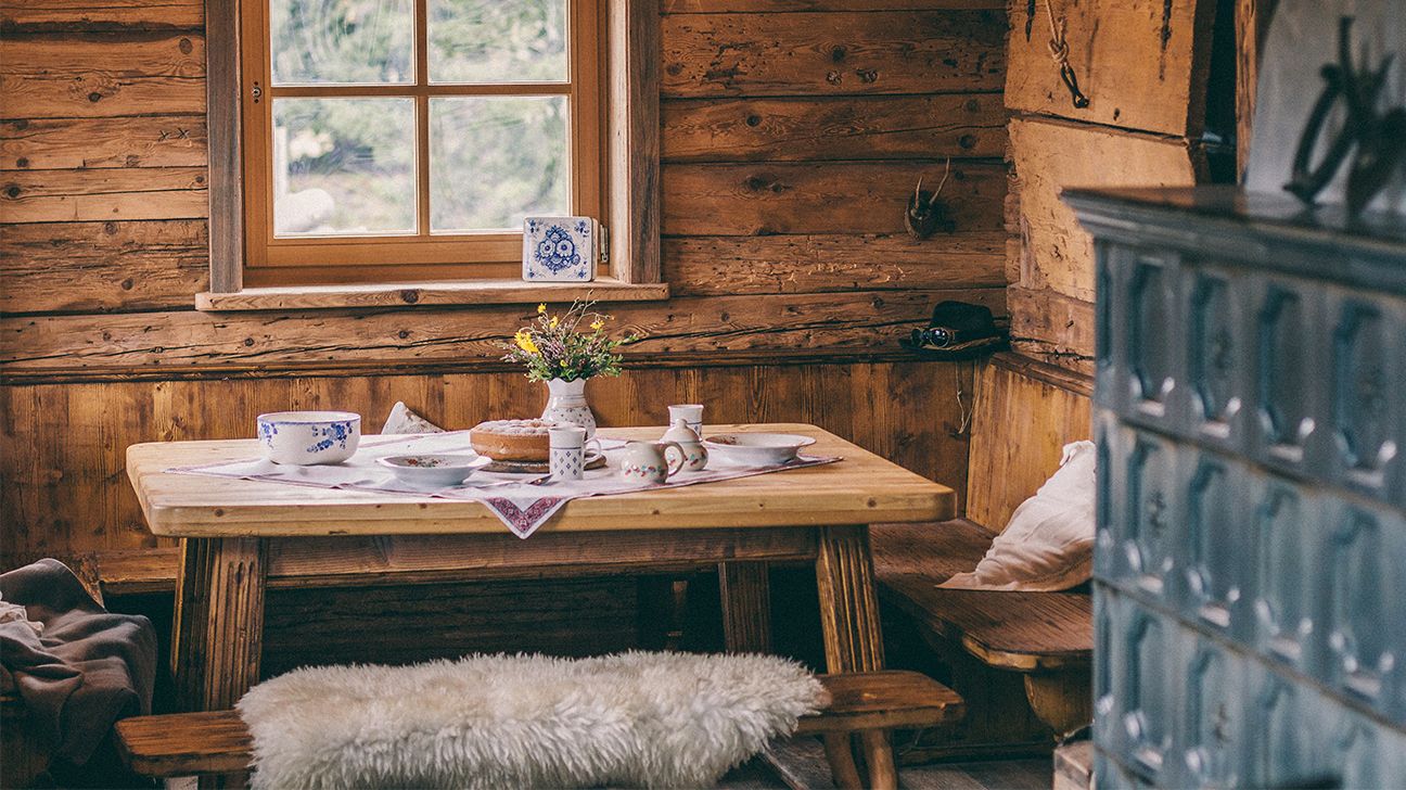 rustic design; wooden kitchen table in a cottage 