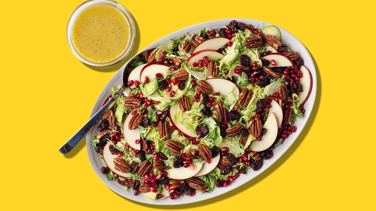 Shredded brussels sprout and pecan salad for thanksgiving on yellow background header