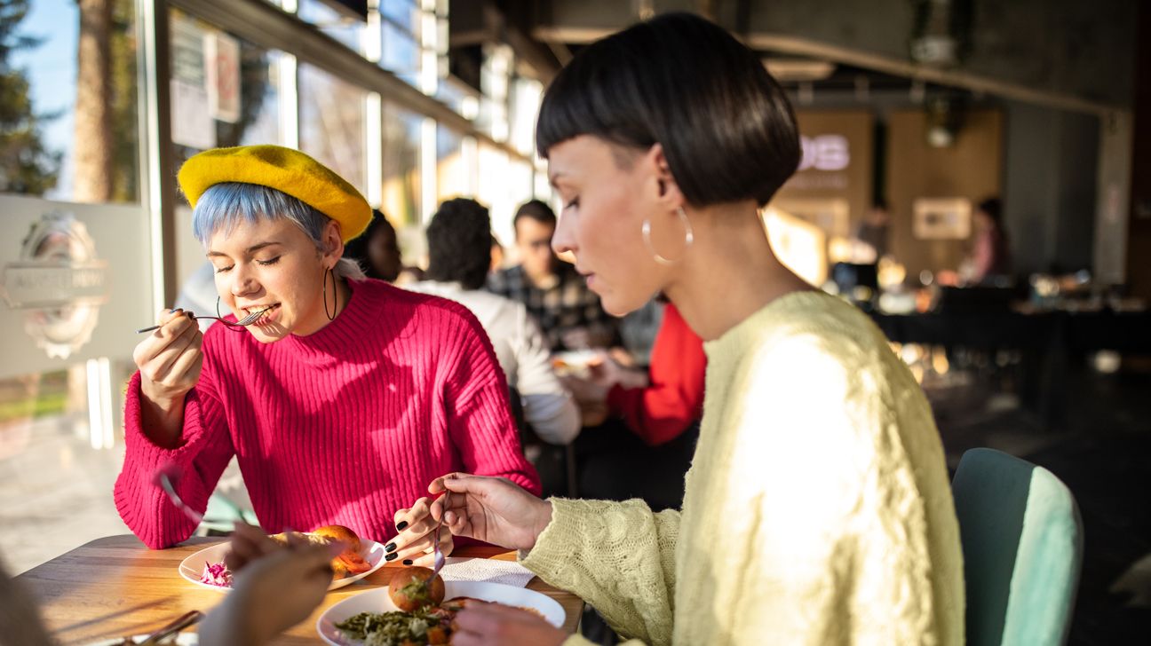 Trendy looking women eating a warm salad while it's cold outside header