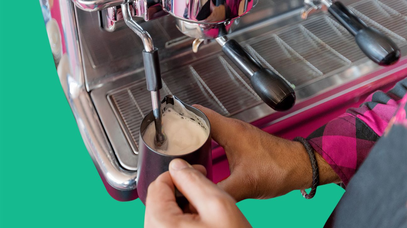 a fancy milk frother attachment on a commercial espresso machine