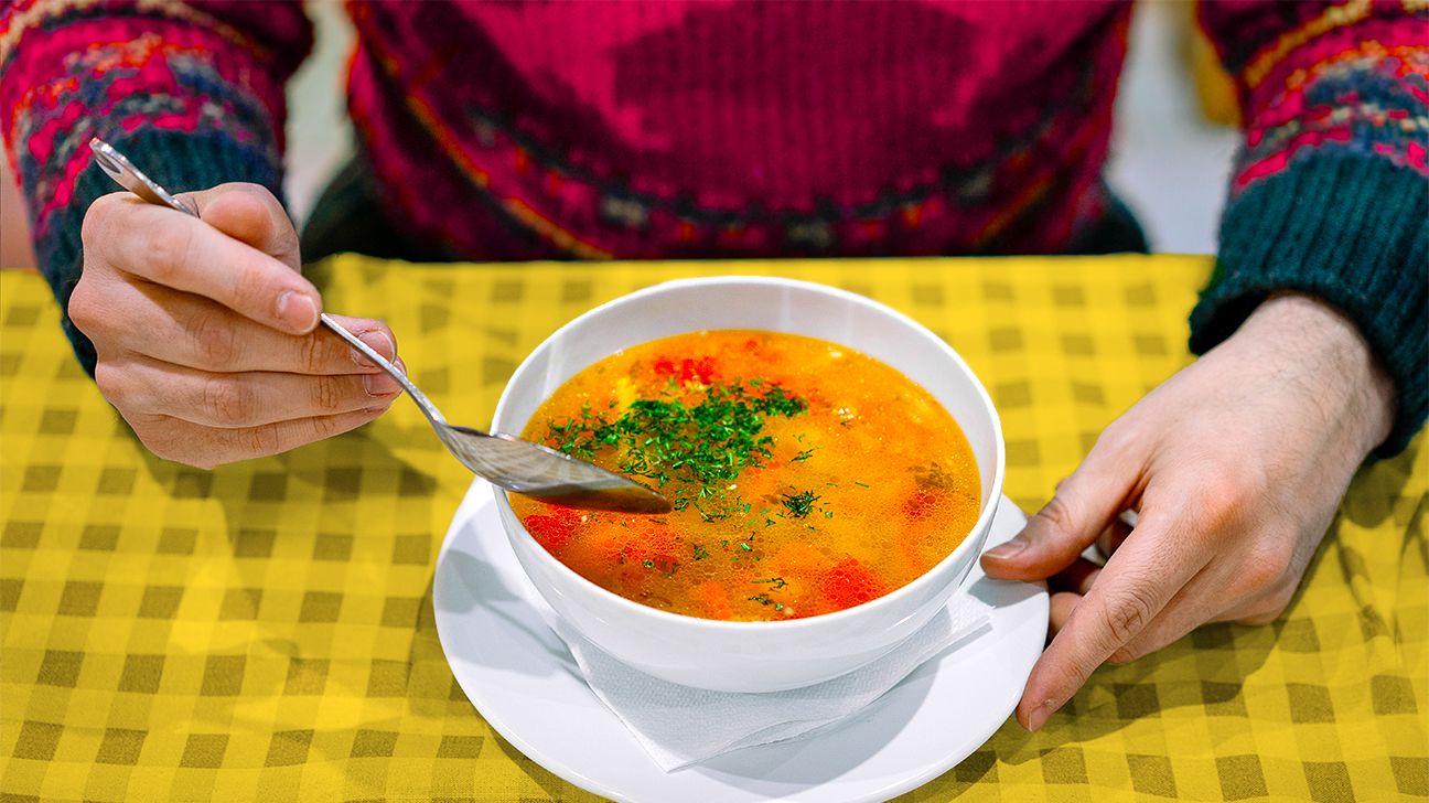 Close-Up Of Hand Eating Soup In Bowl Made From 5 Ingredients On Table header