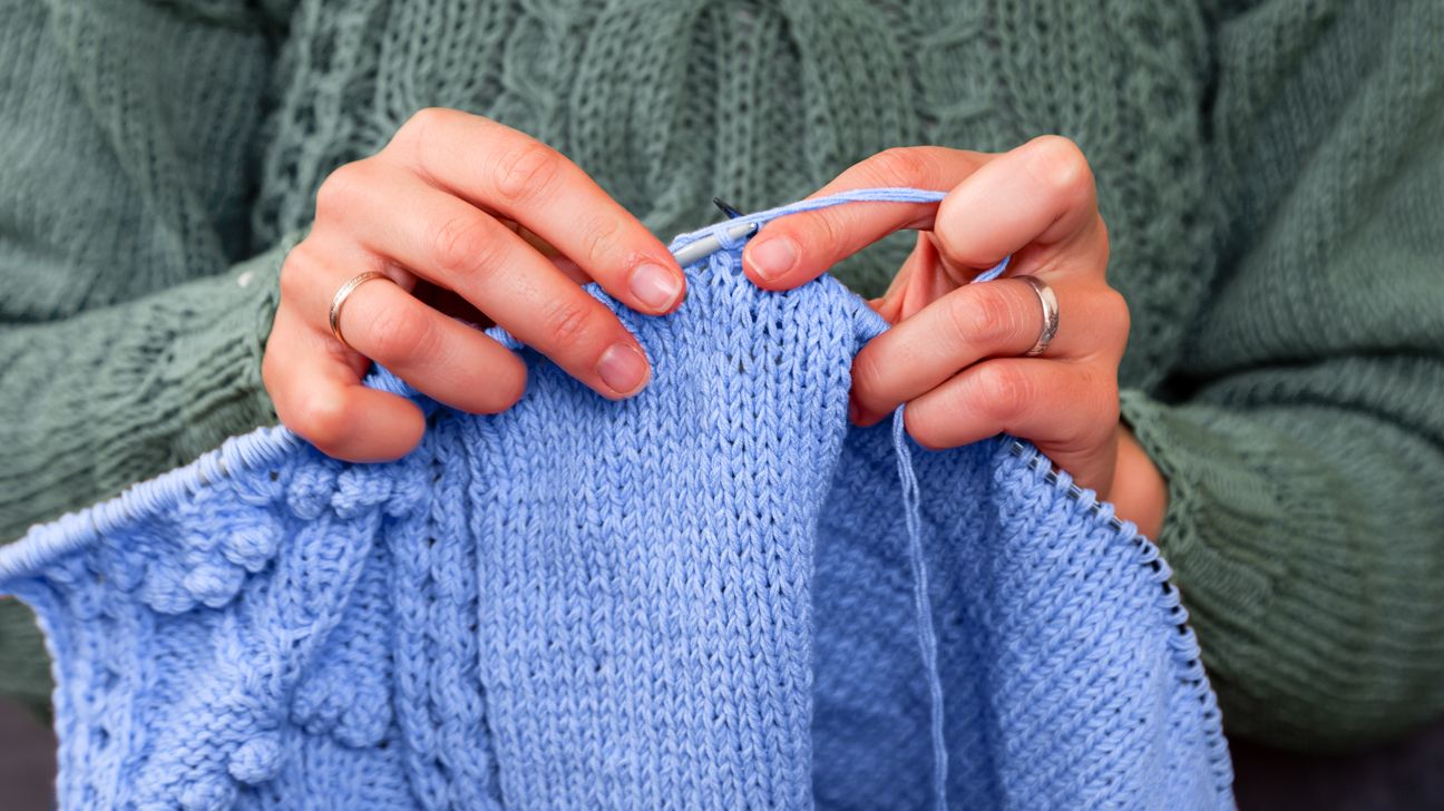 Person knitting as their hobby at home header