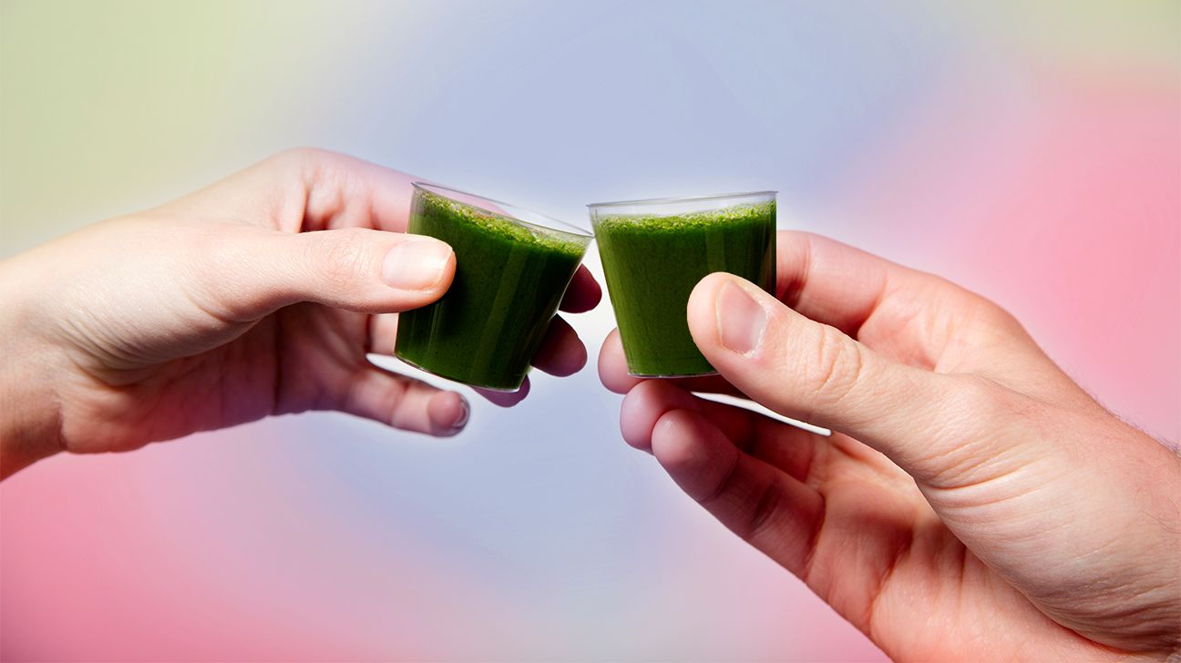 https://media.post.rvohealth.io/wp-content/uploads/sites/2/2021/01/GRT-green-juice-shots-hands-1296x728-header.jpg