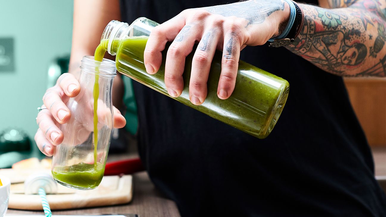 Cropped shot of a happy healthy woman having detox smoothie at spa