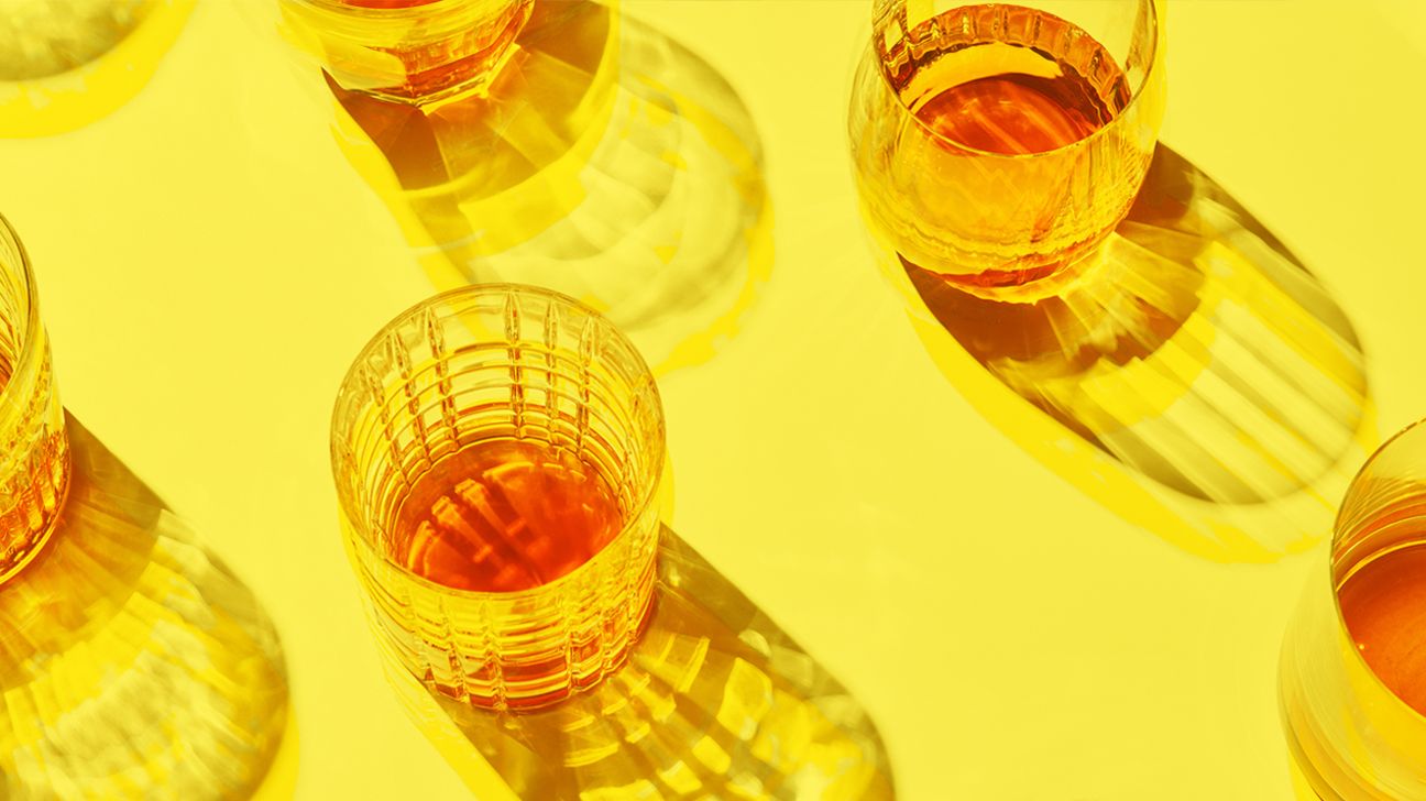 glasses of rum on yellow background header