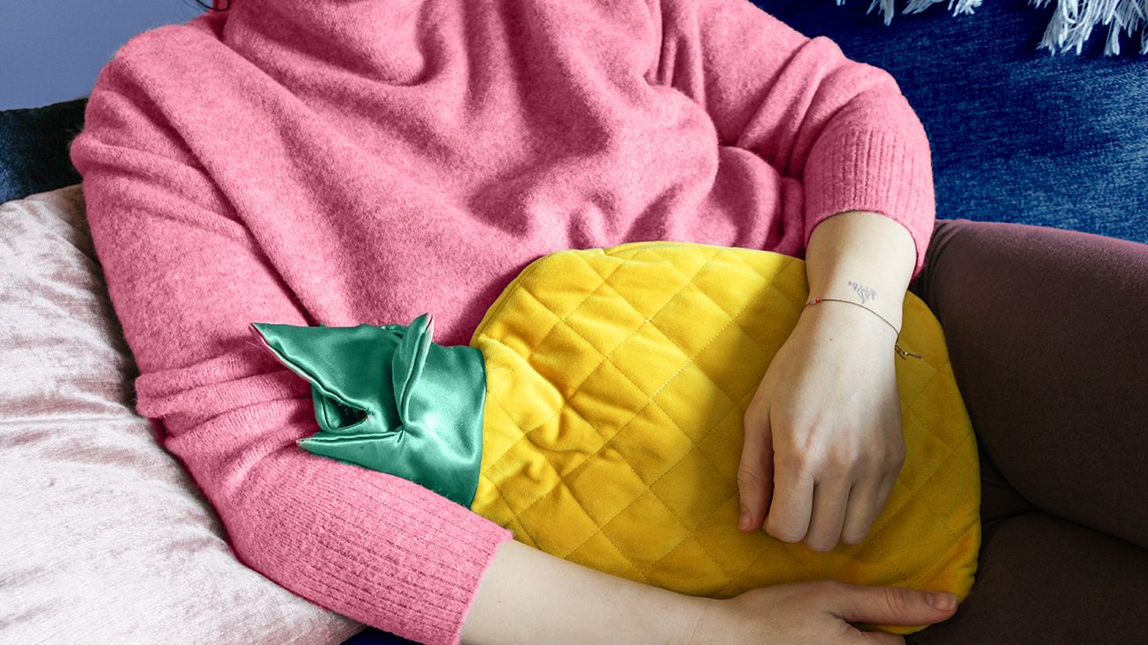 closeup on a young woman with a kidney infection, holding a pillow
