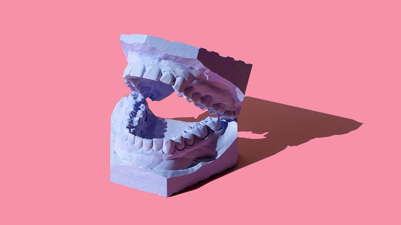 purple teeth mold on a pink background; dry sockets