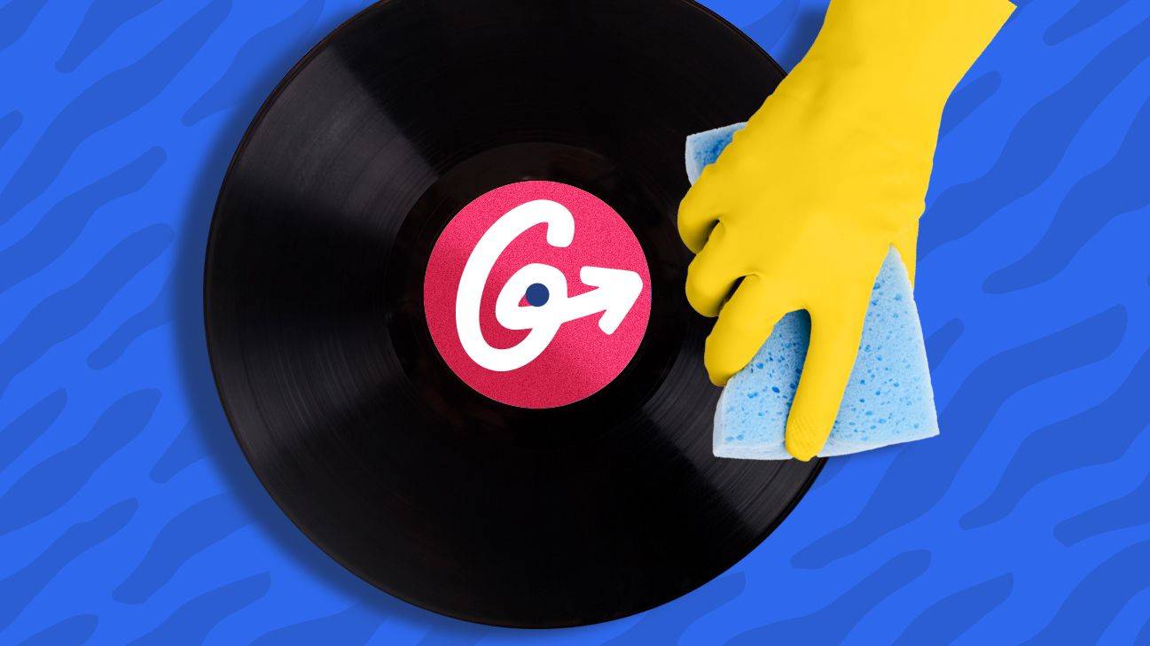 person using sponge to wipe off record with Greatist logo
