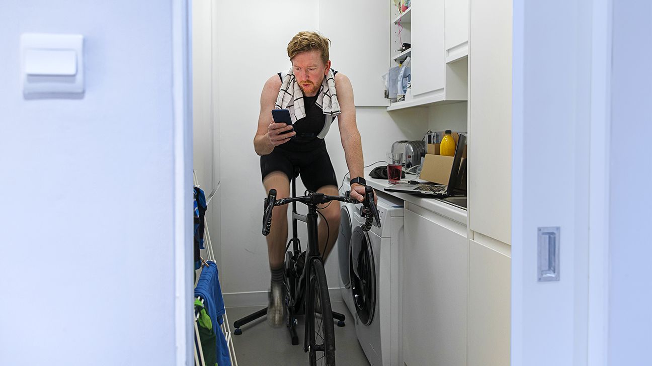 https://media.post.rvohealth.io/wp-content/uploads/sites/2/2021/04/GRT-male-riding-bike-indoors-fitness-1296x728-header.jpg