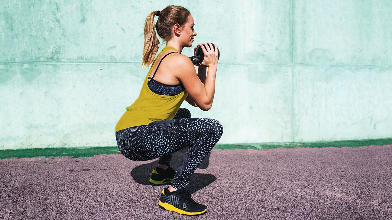 Woman Learning How to Do Deep Squats Safely for Max Results