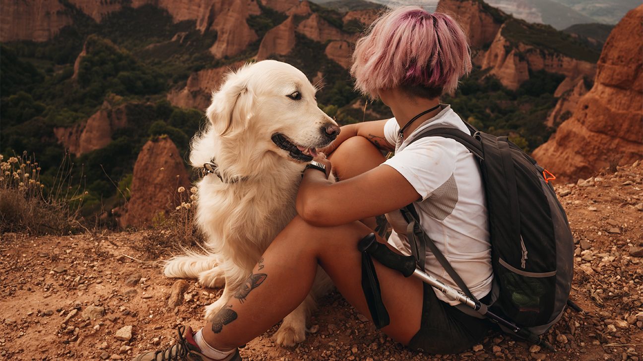 female hiking with a dog