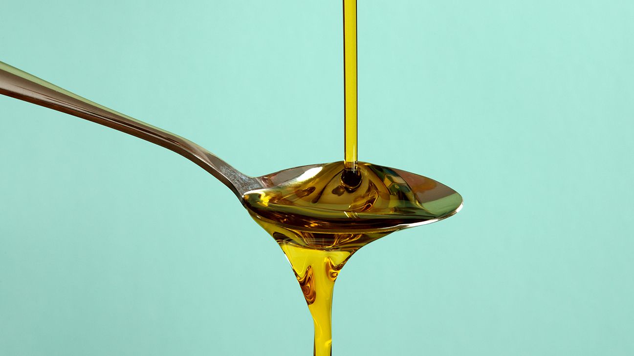 oregano oil poured onto spoon