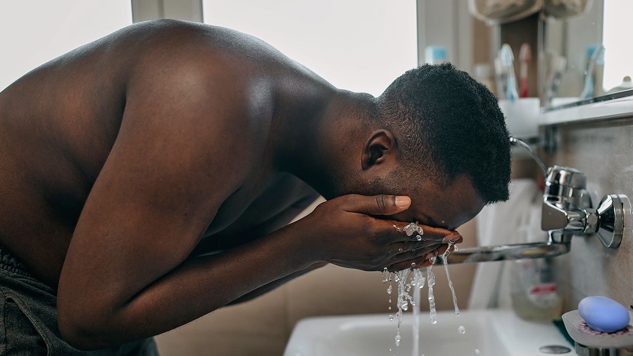 retinoid vs retinol black male washes face header