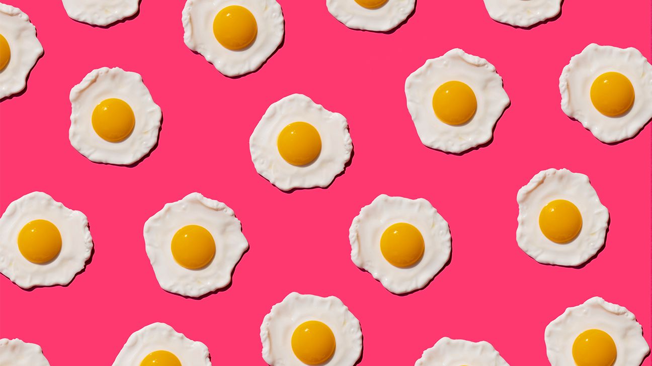 Sunny-side up eggs on pink background