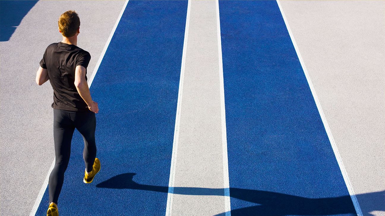 man running on blue track header