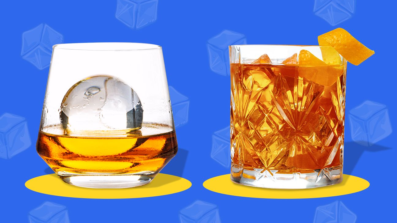 Glass of Old Whiskey with Ice Cubes on Wooden Background. Concept