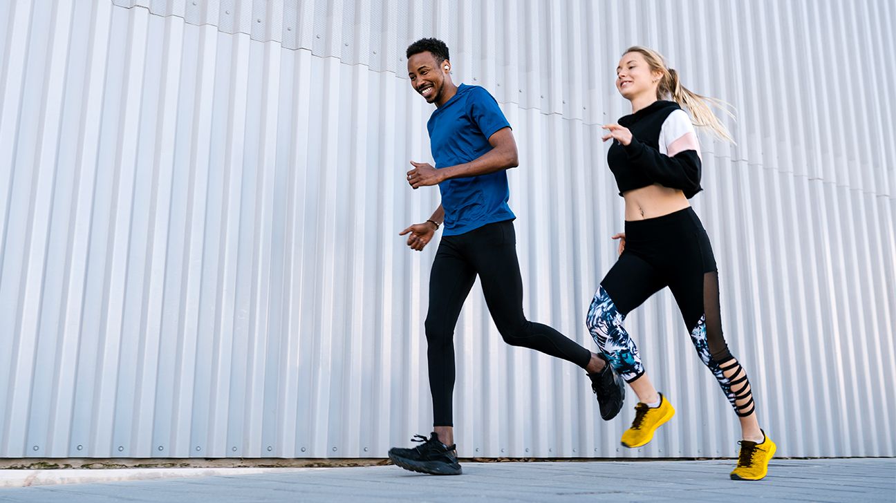 Jogging couple. African american persons man and woman running