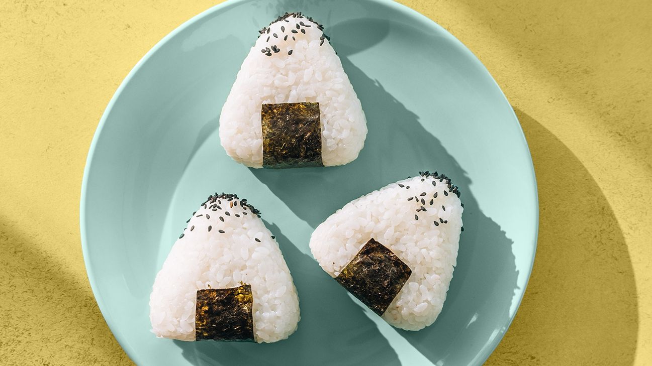 white rice shaped into triangles on blue plate