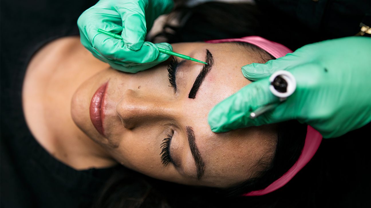 person having their eyebrows microbladed