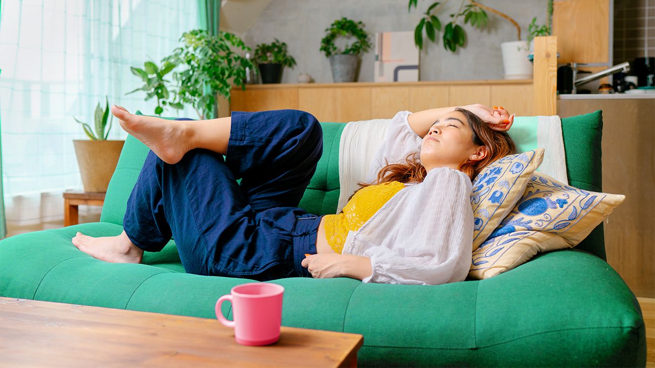 person lounging on green couch