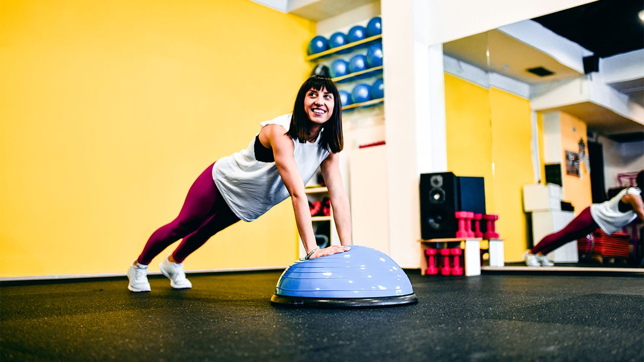 person performing incline push ups in a yellow room