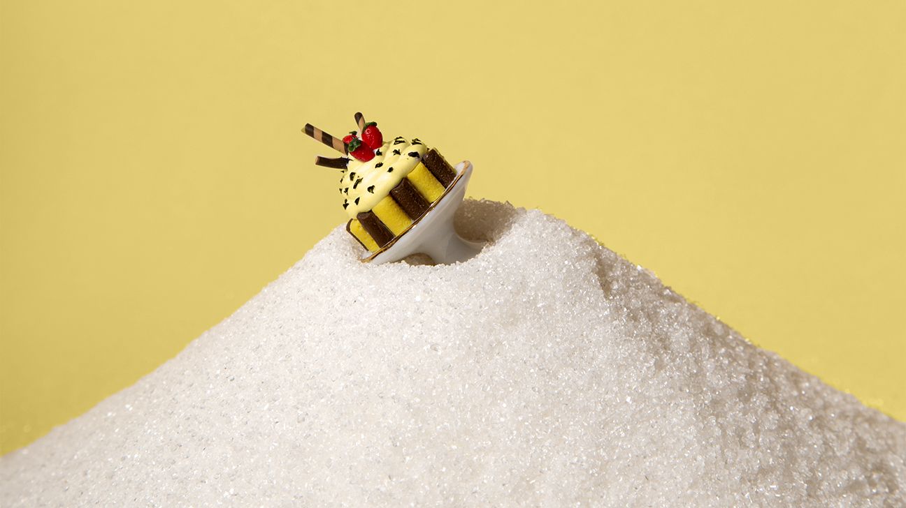 cake spinning top on top of a pile of sugar header