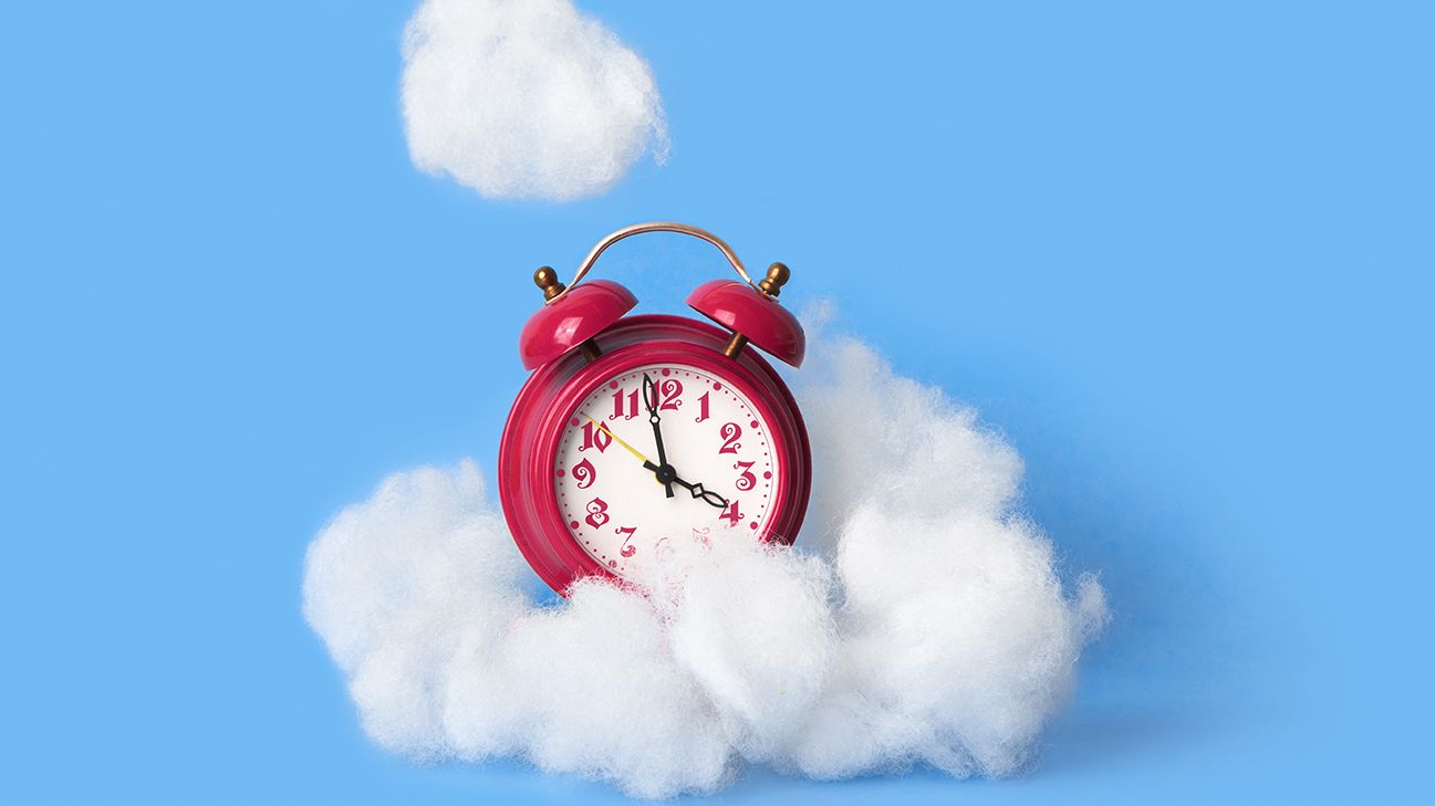 pink alarm clock in clouds