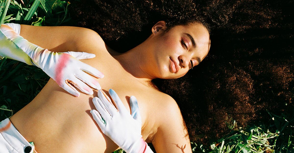 https://media.post.rvohealth.io/wp-content/uploads/sites/2/2022/02/GRT-female-covering-breasts-laying-in-grass-1200x628-facebook-1200x628.jpg