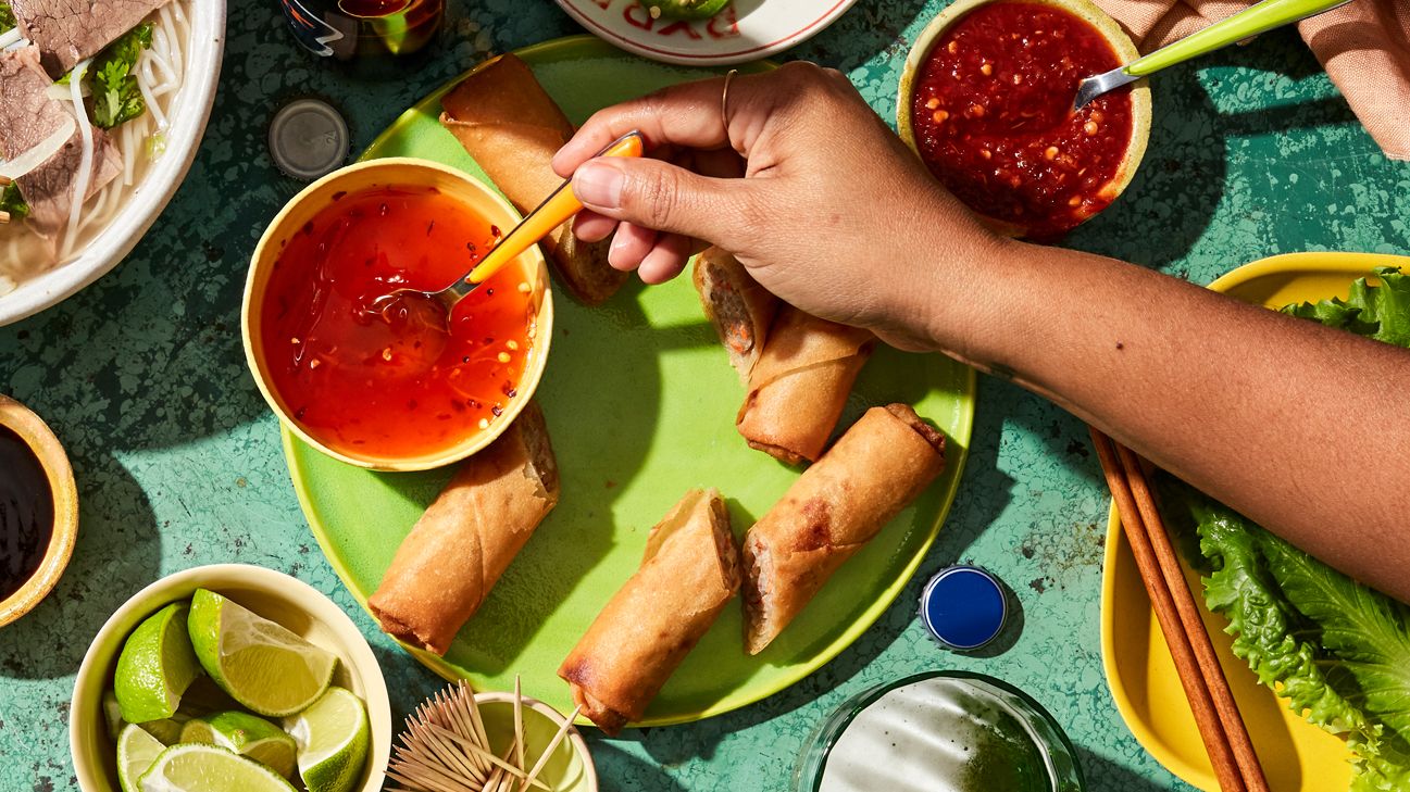 plate of egg rolls with dipping sauce