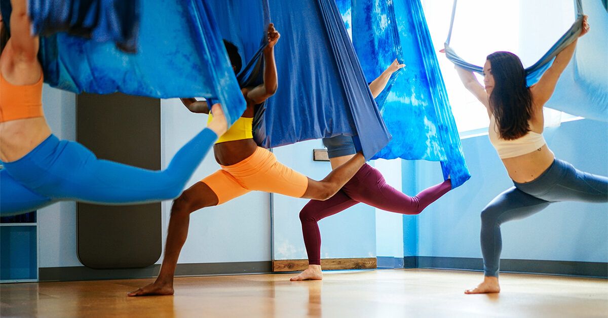 Premium Photo | Attractive young woman doing antigravity yoga using blue  hammock in studio lady doing side splits