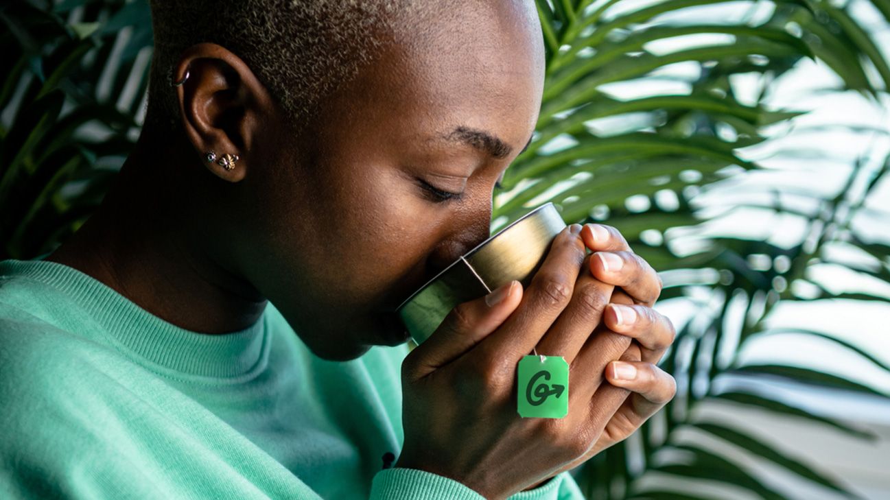 person drinking cup of peppermint tea