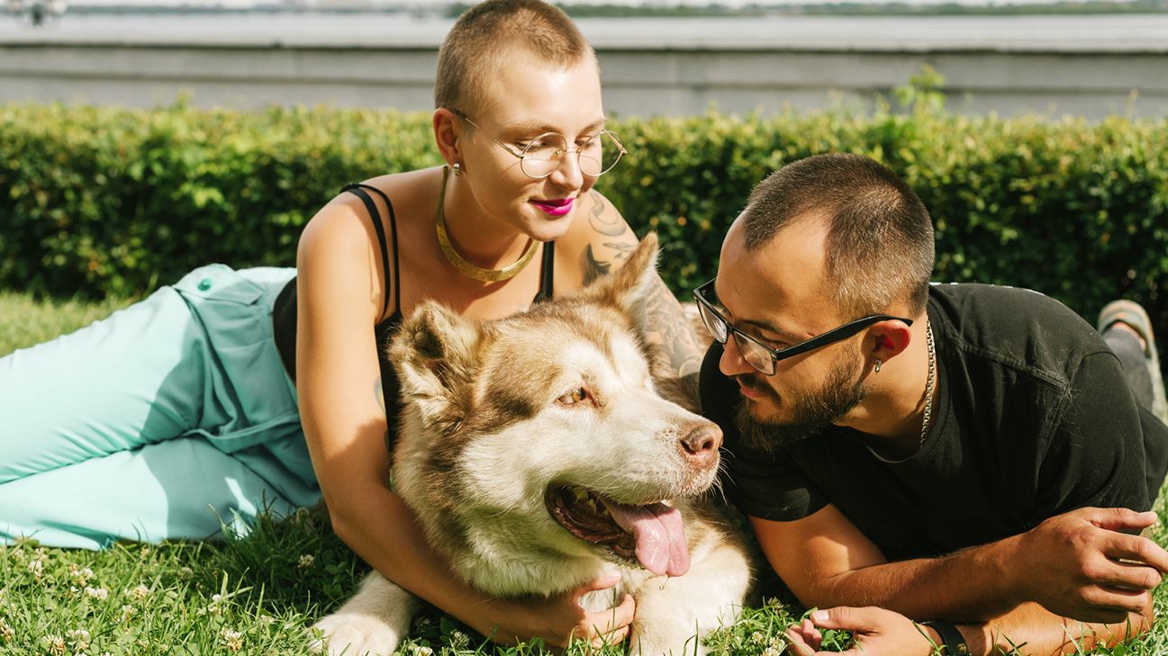 Dog owners outside with a dog