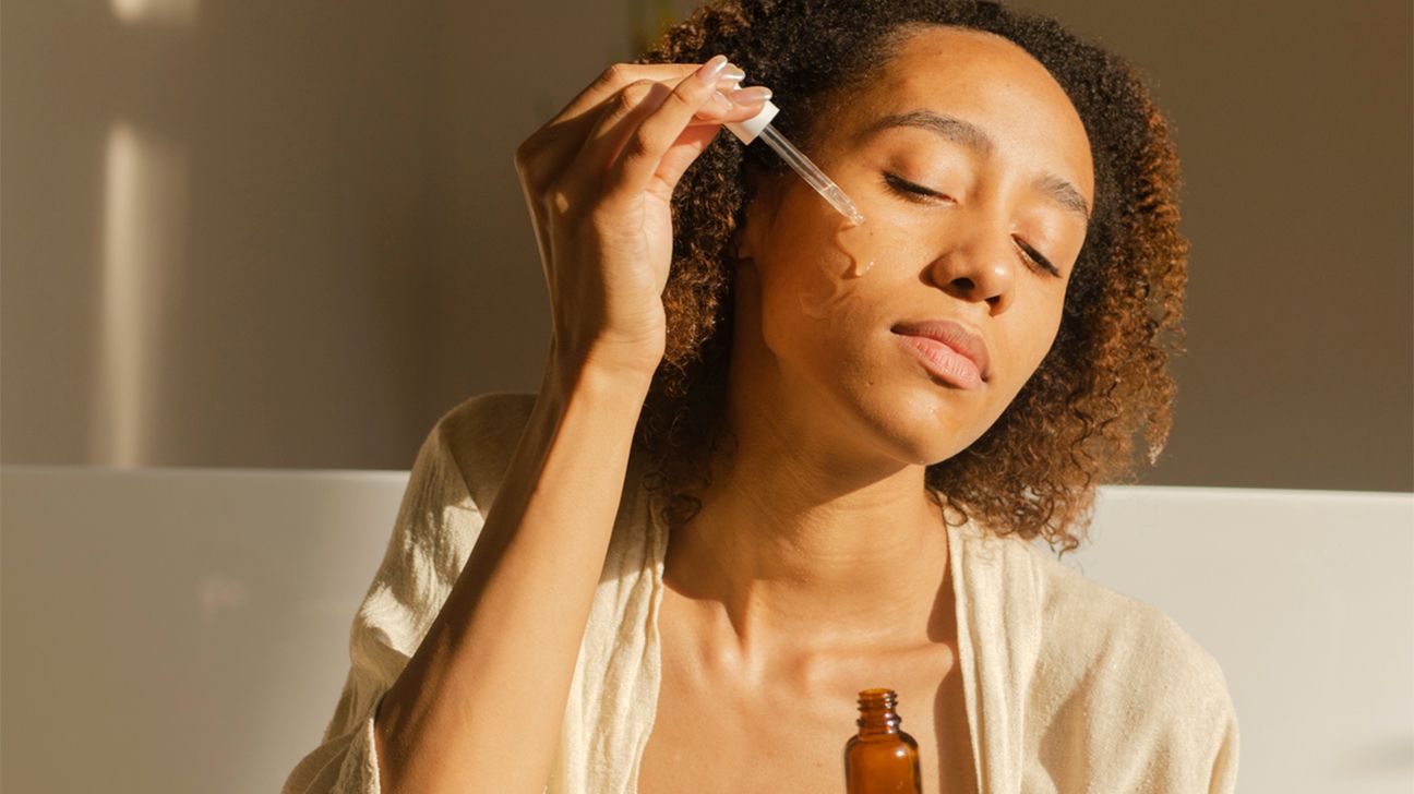 female applying salicylic acid serum