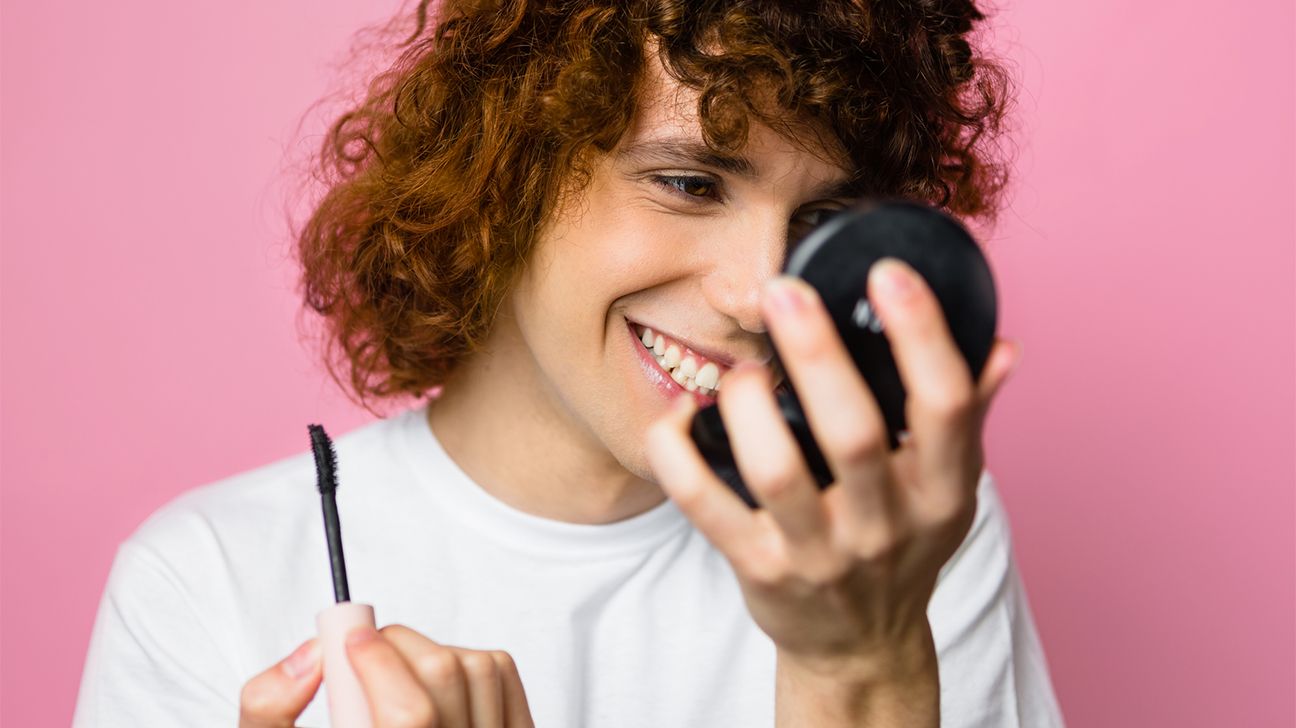 person looking at eyes in compact