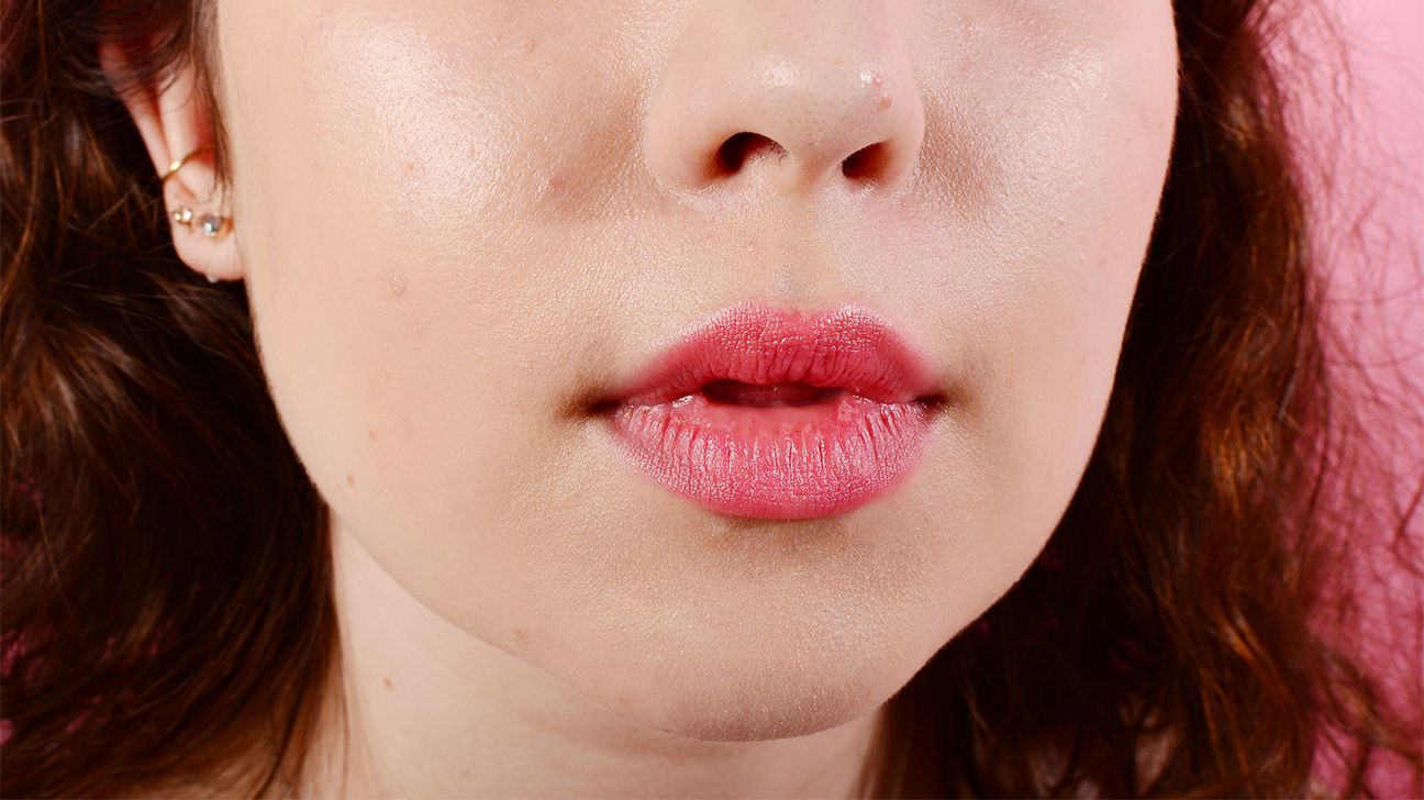 close-up of a woman with a zit on her nose