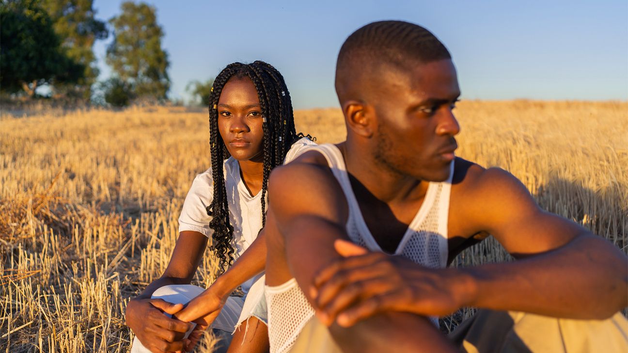 A couple sitting in a field