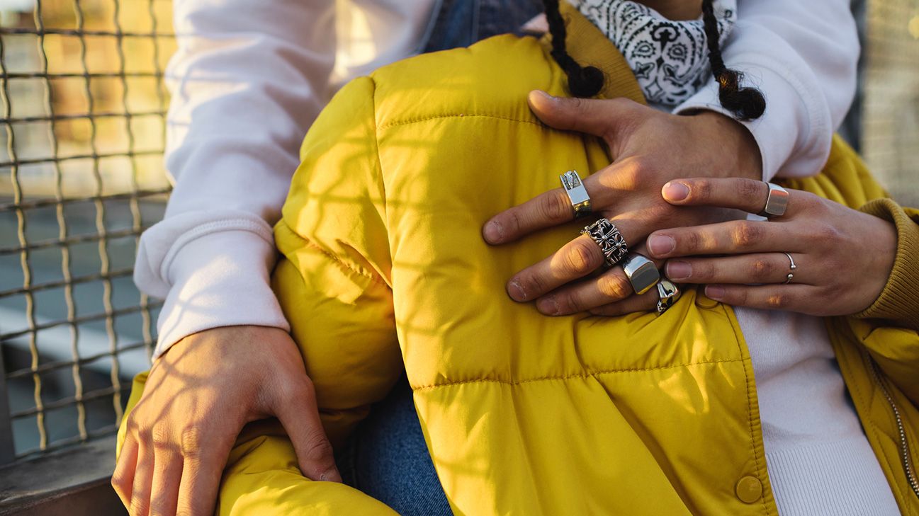 close up of two people holding hands