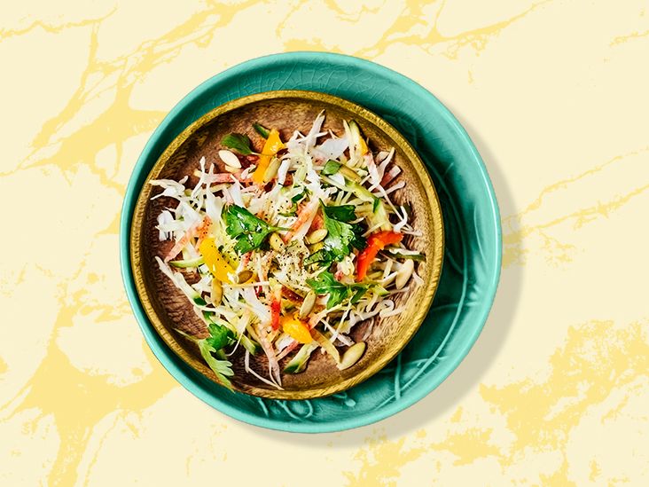 Coleslaw in bowl on yellow background