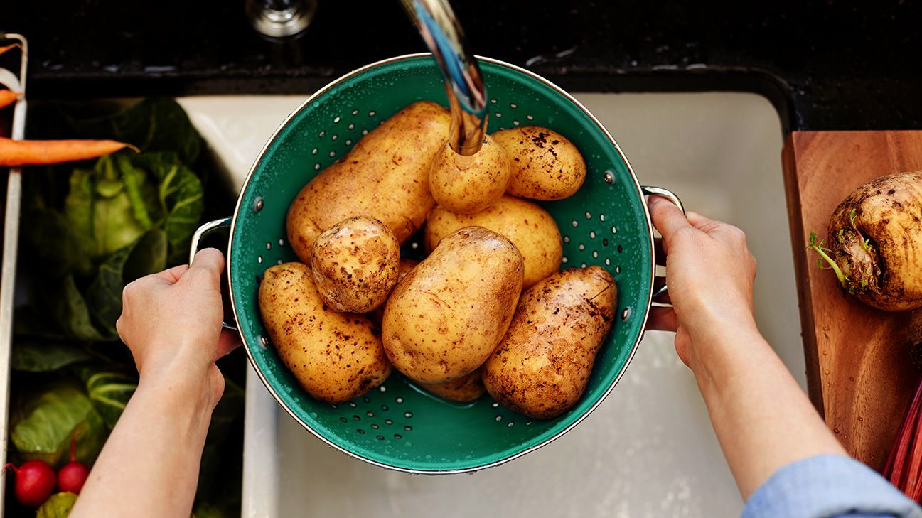 bowl of potatoes being rinsed