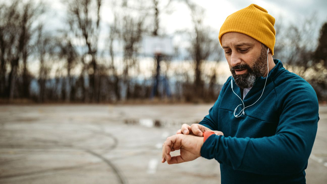 man looking at fit watch