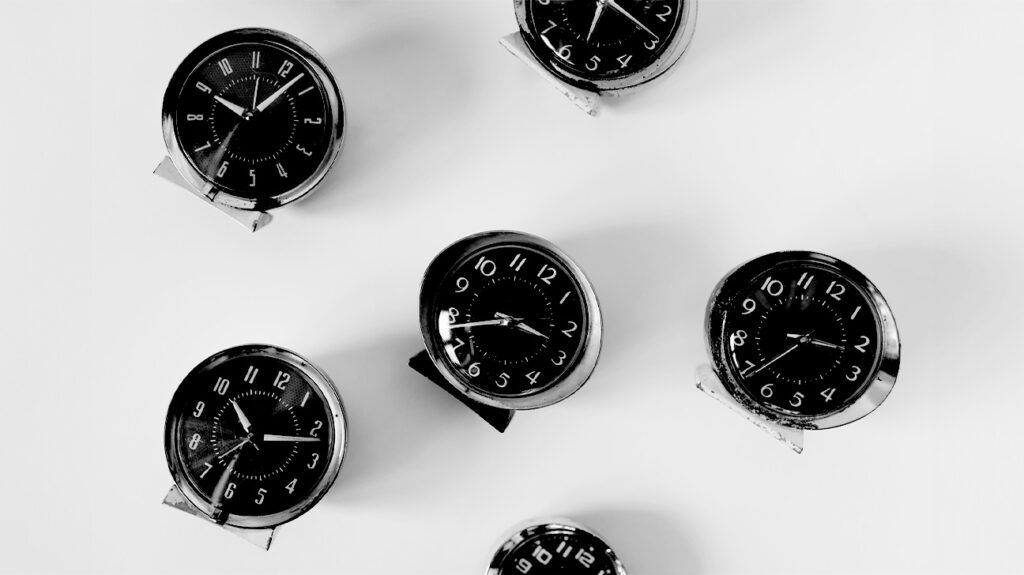 an arrangement of vintage alarm clocks
