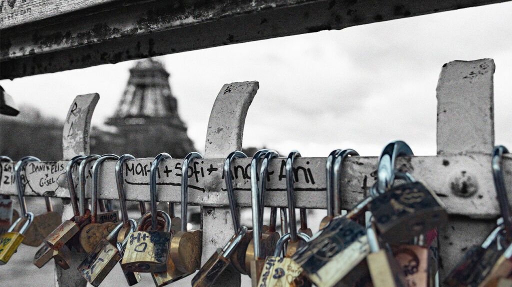 photo of love locks attached to bridge railing