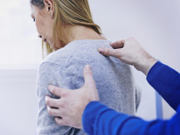 https://media.post.rvohealth.io/wp-content/uploads/sites/3/2020/03/woman-with-upper-back-shoulder-and-neck-pain-at-chiropractor-or-physical-therapists-732x549.jpg