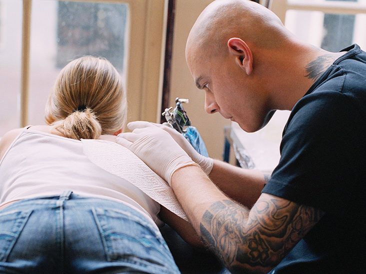 A tattoo artist tattoos a woman s leg during the Slovenia Tattoo Convention  in Ljubljana, Slovenia