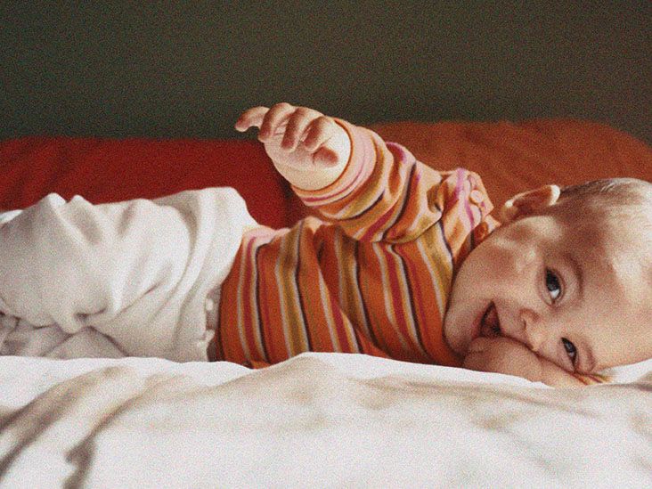 Baby rolling over in sleep When is too early and what to do