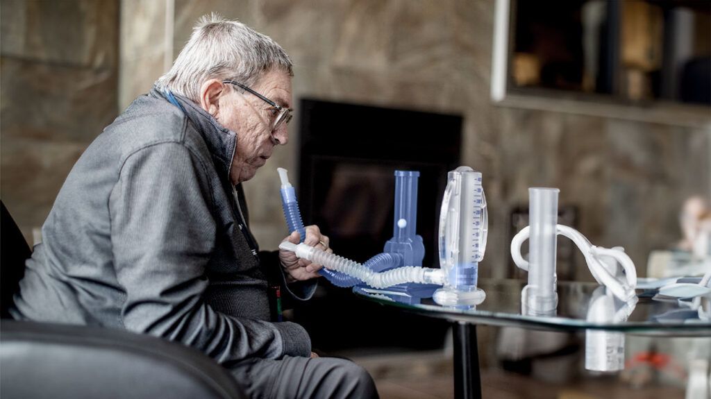 Senior man using disposable spirometers