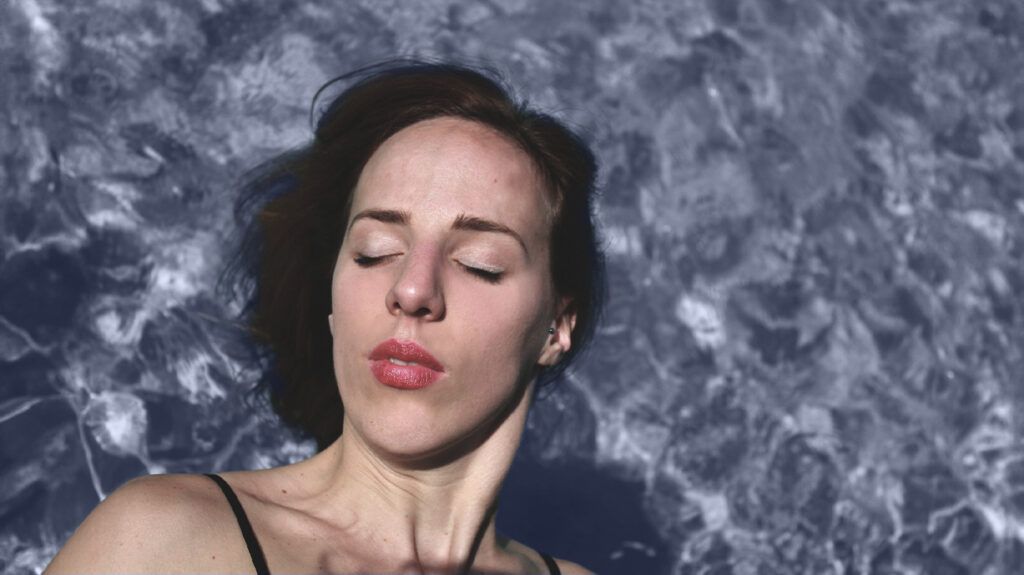 a woman asleep with her head in water