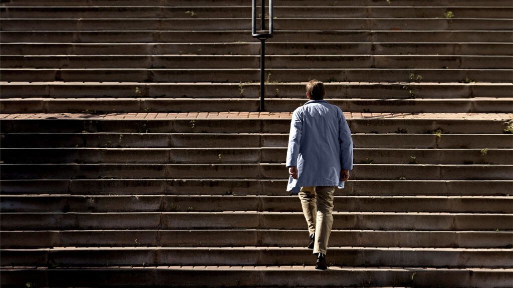 a man walking up a large flight of steps