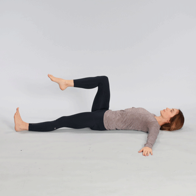 Person doing supine spinal twist.