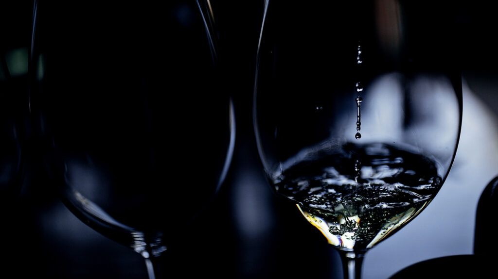 White wine pouring into a wine glass. -2